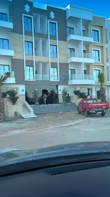 a red truck parked in front of a building at Aqva infinity resort c102 in Hurghada