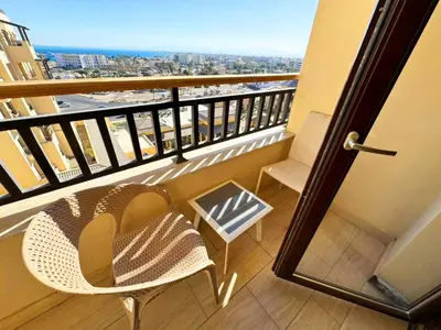 a balcony with a chair and a view of the city at Apartment Aldau in Hurghada