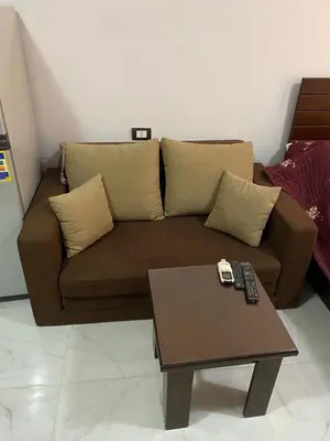 a brown couch in a living room with a coffee table at Taiba View Studio in Hurghada