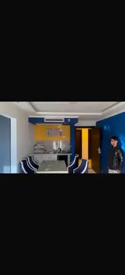 a man is standing in a room with chairs at 1 bedroom apartment hurghada in Hurghada