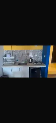 a kitchen with white cabinets and a stove top oven at 1 bedroom apartment hurghada in Hurghada