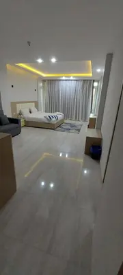 a large room with two beds and a couch at Minaland Beach Resort & Aquapark in Hurghada