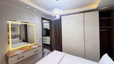 a bedroom with a large mirror and a bed at Hurghada HUB Resort in Hurghada