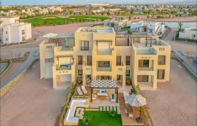 an aerial view of a large yellow house at Serene Lakeview Escape 2BR at Cyan ElGouna in Hurghada