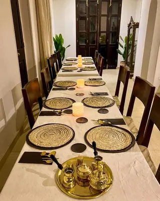 a long table with plates and utensils on it at Al Wadi Hotel in Al Aqālitah