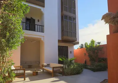 a courtyard of a building with chairs and tables at Al Wadi Hotel in Al Aqālitah