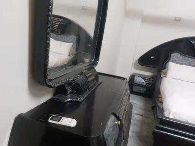 a mirror on a dresser with a cell phone on it at الاقصر امتداد ش التليفزيون in Luxor