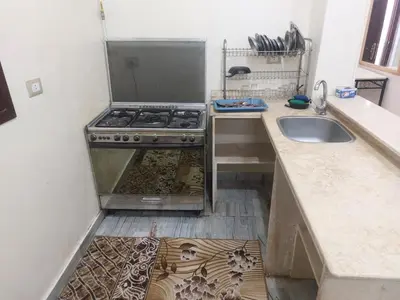 a kitchen with a stove and a sink at الاقصر امتداد ش التليفزيون in Luxor