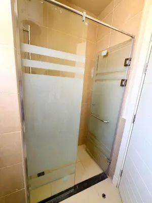 a shower with a glass door in a bathroom at Hurghada Apartment Makadi Lagon & Swimming Pools Free in Hurghada