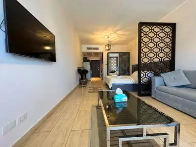 a living room with a couch and a tv at Aldau Maxico in Hurghada