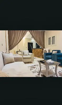 a living room with two couches and a table at Nile palace apartment in Luxor