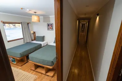 a small room with two beds and a window at Escaleeh Dahabiya Tranquil sailing in Jazīrat Suhayl