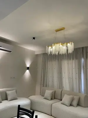 a living room with a couch and a chandelier at Luxurious 3Bd Living Awaits in El Gouna in Hurghada
