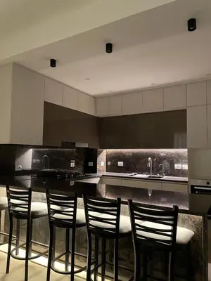 a kitchen with a bar with four chairs in it at Luxurious 3Bd Living Awaits in El Gouna in Hurghada