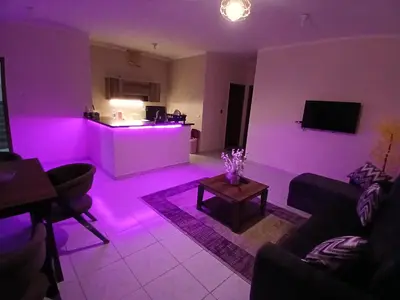 a living room with purple lighting in a living room at Yulla apartment in Hurghada