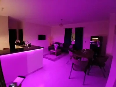 a living room with purple lights in a room at Yulla apartment in Hurghada