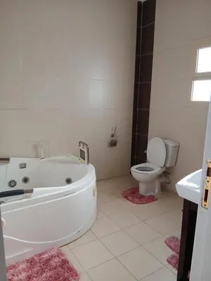 a bathroom with a white tub and a toilet at Villa yulla in Hurghada