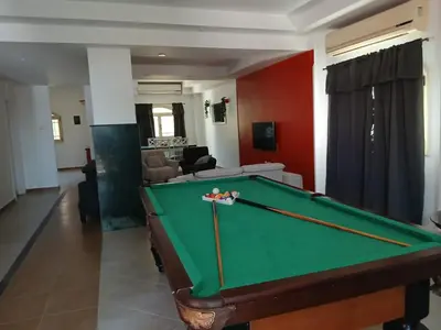a living room with a pool table in it at Cozy Villa in Hurghada