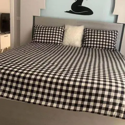 a bed with a black and white checkered blanket at West Side B 1 2 in Hurghada