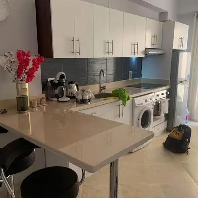 a kitchen with a counter with a sink and a dishwasher at West Side B 1 2 in Hurghada