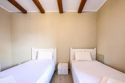two beds in a room with white walls at Luxury 2BR Bali • Heated Pool in Hurghada
