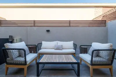 two chairs and a bench on a patio at Luxury 2BR Bali • Heated Pool in Hurghada