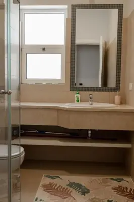 a bathroom with a sink and a mirror at Exquisite 2 Bdr Apartment Waterside in Hurghada