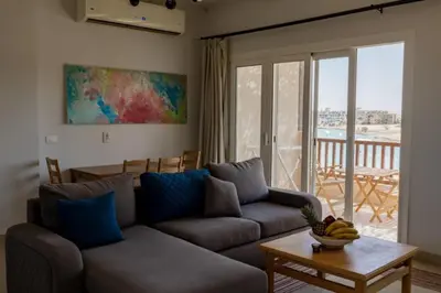 a living room with a couch and a table at Exquisite 2 Bdr Apartment Waterside in Hurghada