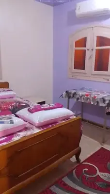 a bedroom with a bed and a table with pillows at elqusier redsea in Quseir