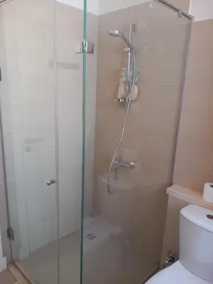 a bathroom with a shower with a glass door at Blue Lagoon View - 2 Bed 2 Bath - Shared Pool - El Gouna in Hurghada