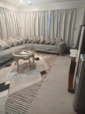 a living room with a couch and a coffee table at Flat in villa San George in Hurghada