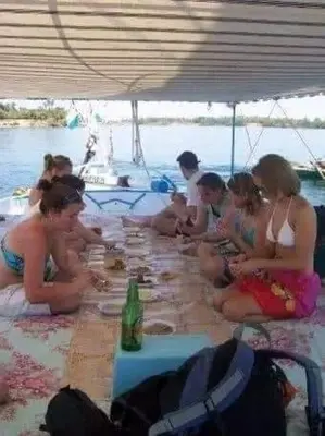 a group of people sitting around a long table at Isis Nubian Services in Jazīrat Aswān