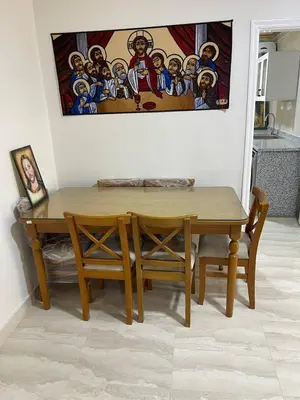 a dining room table and chairs with a painting on the wall at Aven Resort Compound in Hurghada