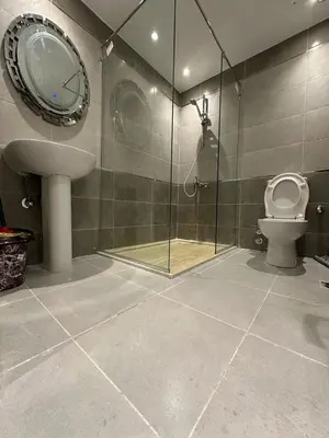 a bathroom with a shower and a toilet and a sink at 2 Bedroom in Al Hambra - Mamsha in Hurghada