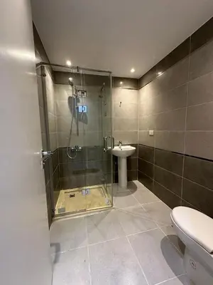 a bathroom with a shower and a toilet and a sink at 2 Bedroom in Al Hambra - Mamsha in Hurghada