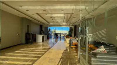 a hallway in a building with people sitting on couches at Elite AlDaU Heights in Hurghada
