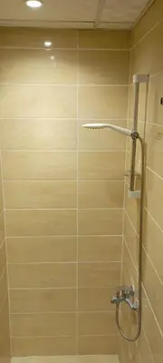 a bathroom with a shower with a glass door at Compound floranza in Hurghada