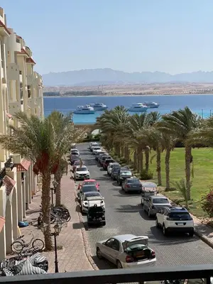 a row of cars parked on a street next to the water at Sea view Luxury apartment at Al Andalous Sahl Hasheesh in Hurghada