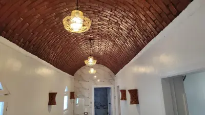 a hallway with a brick ceiling and lights at Nature House in Luxor