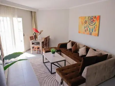 a living room with a couch and a table at Hurghada Scandic in Hurghada