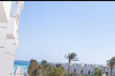 a view of the beach from the balcony of a resort at Hurghada Scandic in Hurghada