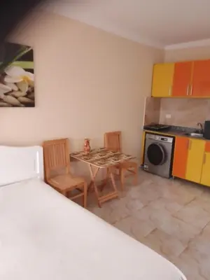 a small kitchen with a table and chairs in a room at Studio on the roof in Hurghada