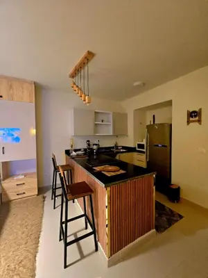 a kitchen with a counter and a refrigerator at Veranda sahl hasheesh in Hurghada