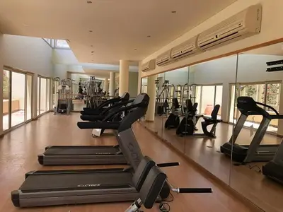 a gym with several treadmills and elliptical machines at Veranda sahl hasheesh in Hurghada