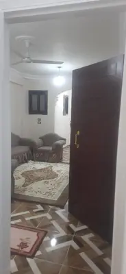 a door leading into a living room with a couch at Sphinx Avenue street in Luxor