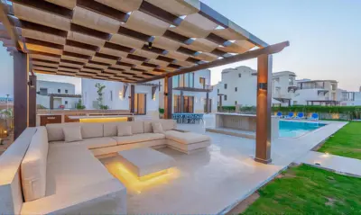 an outdoor living room with a couch and a patio at Luxury Stays in Ancient Sands El Gouna in Hurghada