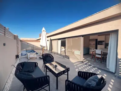a patio with chairs and a table on a balcony at Bali A 22 in Hurghada