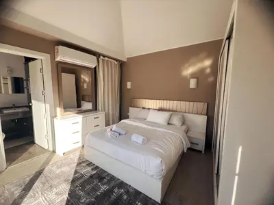 a bedroom with a white bed and a mirror at Bali A 22 in Hurghada
