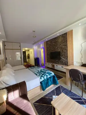 a hotel room with a large bed and a tv at Florienza resort in Hurghada