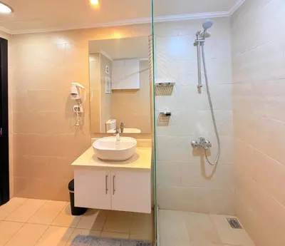 a bathroom with a sink and a glass shower at Hotel Apartment 1 very nice and quiet hurghada in Hurghada
